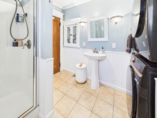 1010 W Main St, Smethport, PA 16749 - full bath featuring stacked washer and dryer, ornamental molding, a wainscoted wall, tile patterned floors, and a shower stall