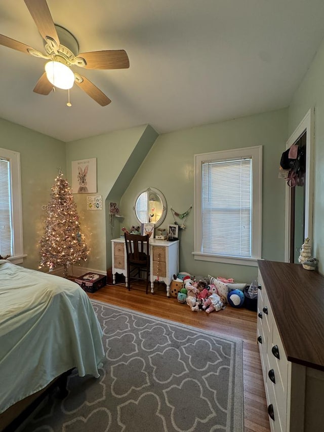 bedroom with ceiling fan and wood finished floors