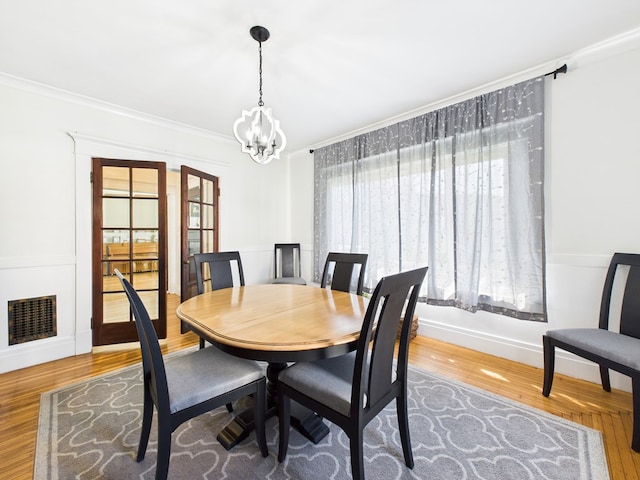 1010 W Main St, Smethport, PA 16749 - dining area with crown molding, a notable chandelier, wood finished floors, and visible vents