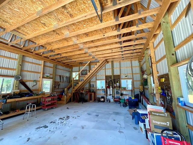 misc room featuring vaulted ceiling and concrete flooring