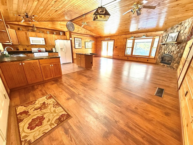 kitchen with white appliances, sink, a kitchen island, and wood ceiling