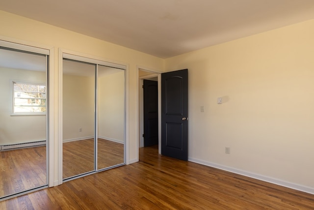 303 E Sullivanville Rd, Horseheads, NY 14845 - unfurnished bedroom with a baseboard radiator and hardwood / wood-style flooring