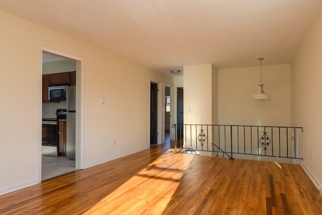 unfurnished room with hardwood / wood-style flooring