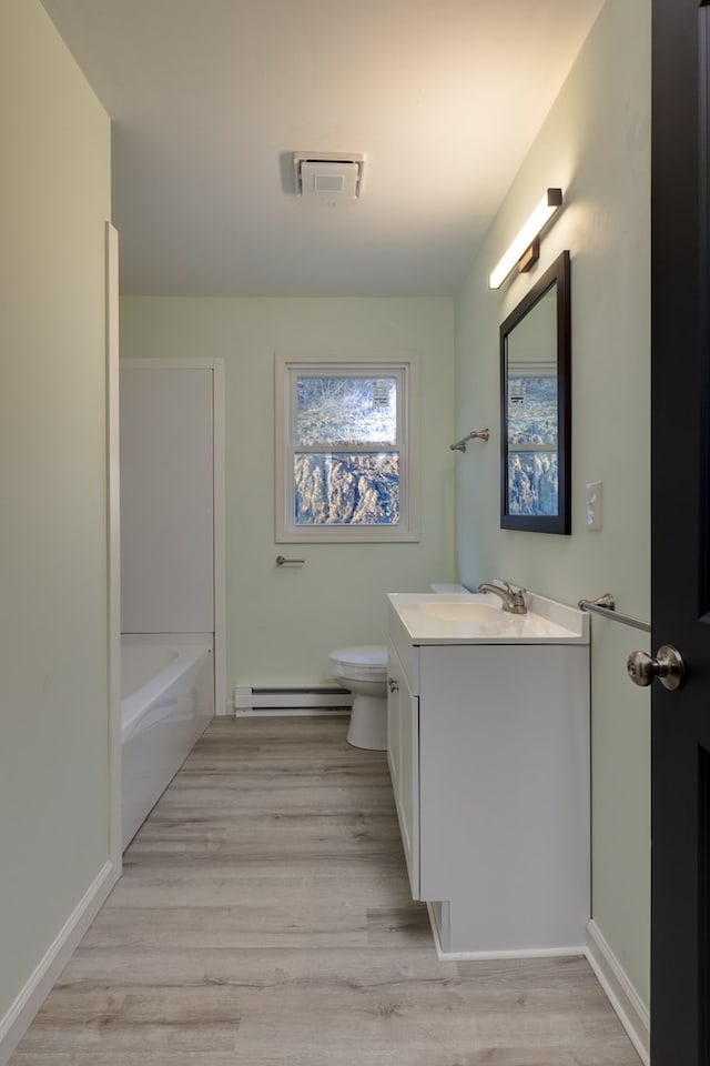 303 E Sullivanville Rd, Horseheads, NY 14845 - bathroom with hardwood / wood-style flooring, vanity, toilet, and a baseboard radiator
