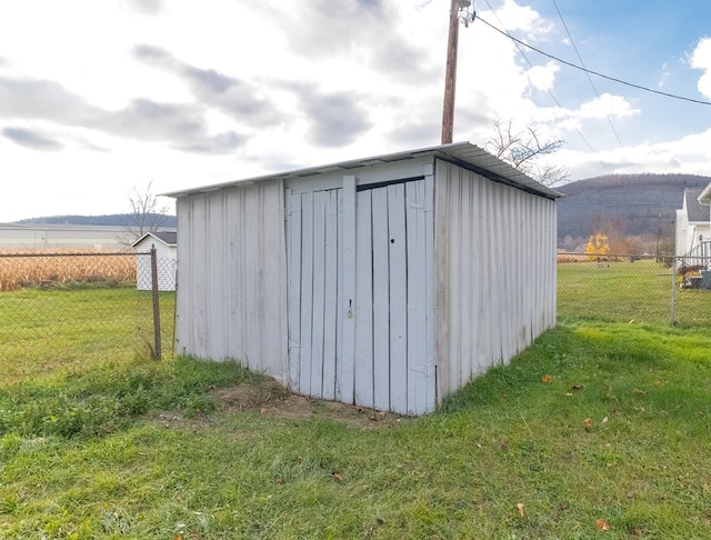 view of outdoor structure featuring a yard and a rural view