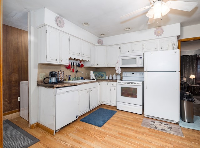 kitchen with white appliances, white cabinetry, light wood-style floors, ceiling fan, and a sink
