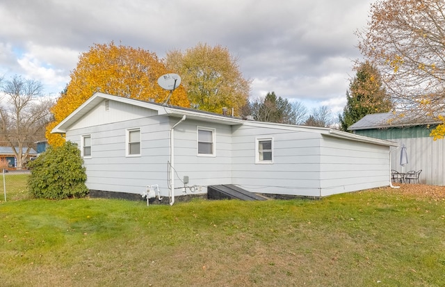 back of house with a lawn