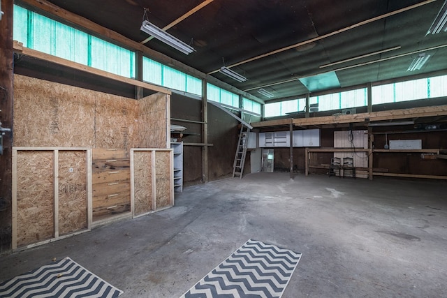 interior space with a garage and unfinished concrete flooring