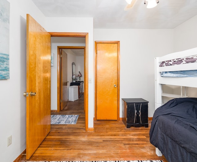 bedroom with hardwood / wood-style floors and ceiling fan