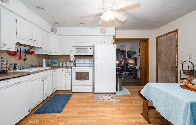 kitchen featuring white appliances, ceiling fan, sink, light hardwood / wood-style floors, and white cabinetry