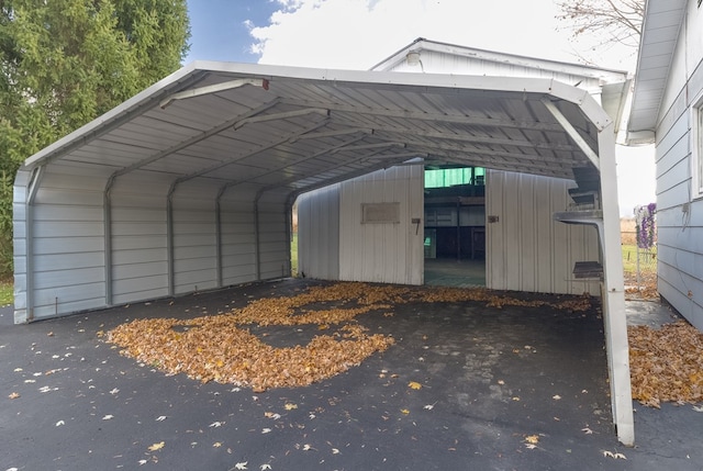 view of parking / parking lot featuring a carport