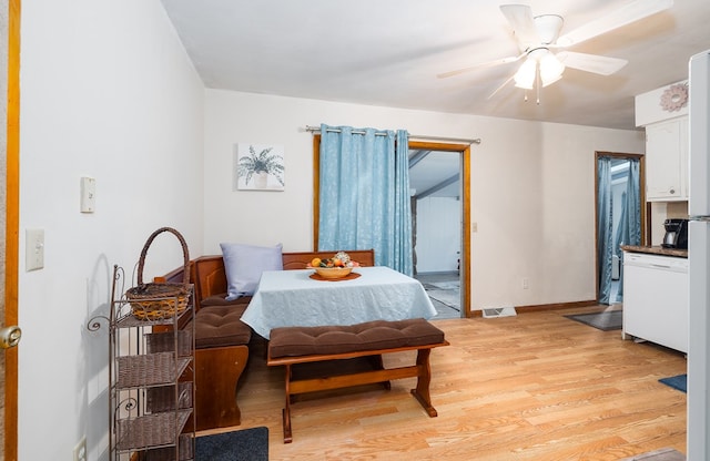 dining room with light hardwood / wood-style floors and ceiling fan