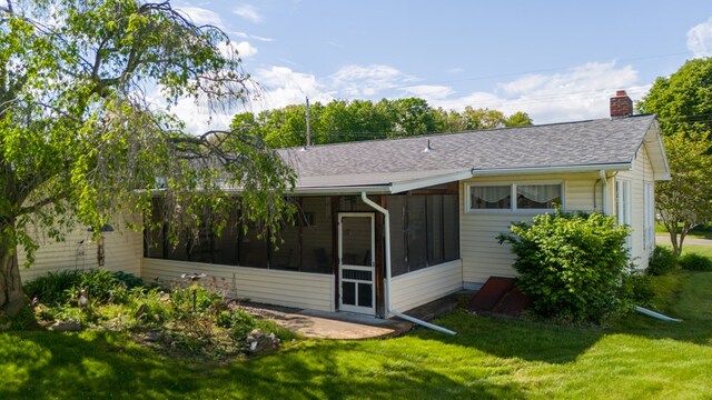 517 Mohawk St, Sayre, PA 18640 - back of property with a chimney, a sunroom, a lawn, and a shingled roof