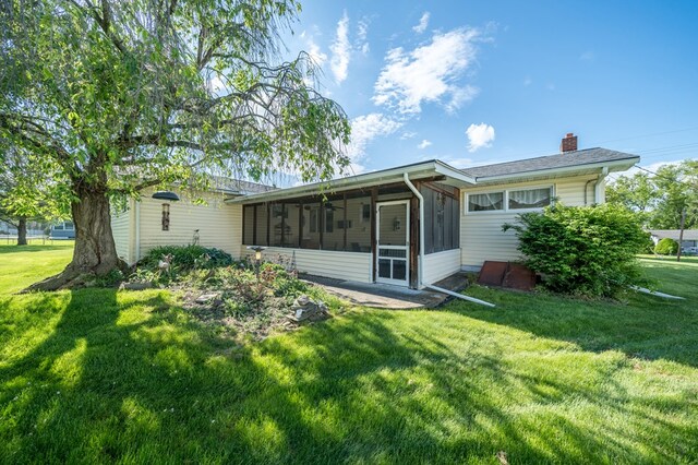 517 Mohawk St, Sayre, PA 18640 - back of house featuring a sunroom, a chimney, and a lawn