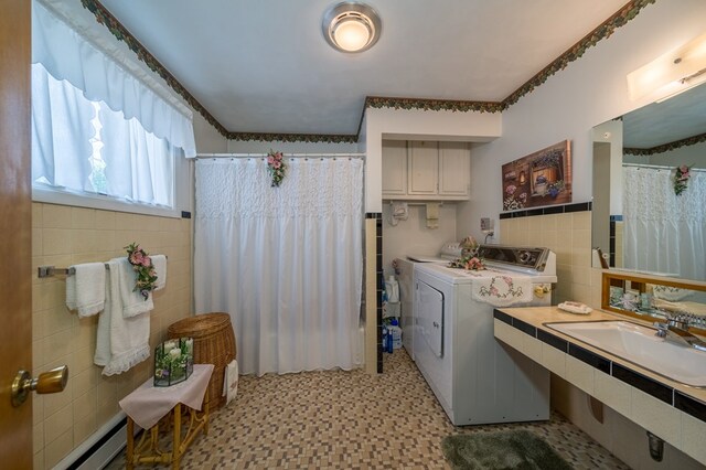 517 Mohawk St, Sayre, PA 18640 - clothes washing area with tile walls, independent washer and dryer, baseboard heating, and light flooring