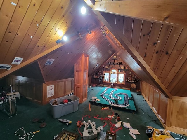 playroom with wood walls, carpet floors, and lofted ceiling