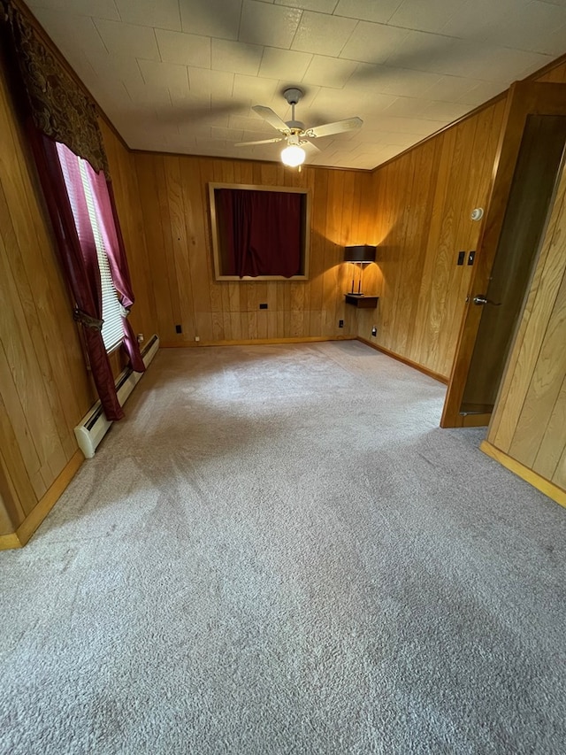 401 Center St, Ulysses, PA 16948 - carpeted empty room featuring ceiling fan, wood walls, and a baseboard radiator