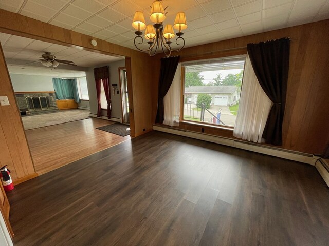 401 Center St, Ulysses, PA 16948 - unfurnished living room featuring a chandelier, dark wood-style floors, a baseboard radiator, ceiling fan, and a fireplace
