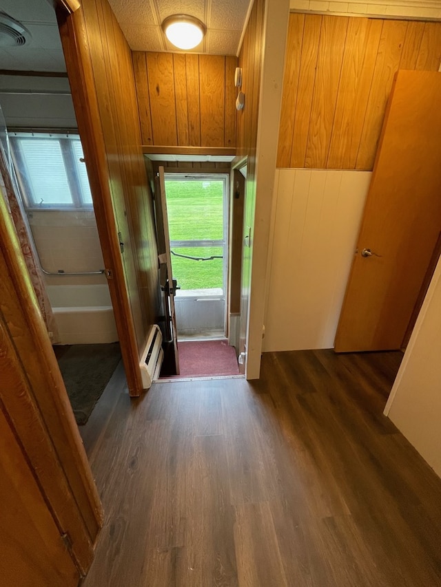 401 Center St, Ulysses, PA 16948 - doorway featuring dark wood finished floors, plenty of natural light, wood walls, and a baseboard heating unit