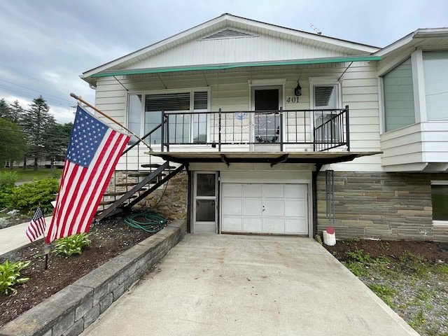 401 Center St, Ulysses, PA 16948 - view of front of home featuring stairway, a garage, stone siding, and a balcony