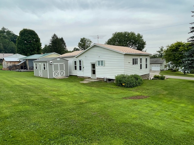 401 Center St, Ulysses, PA 16948 - rear view of house with a storage unit, a yard, and a garage