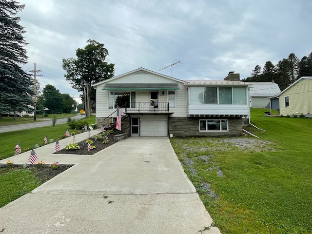 401 Center St, Ulysses, PA 16948 - view of front of property featuring concrete driveway, a front lawn, a chimney, an attached garage, and stairway