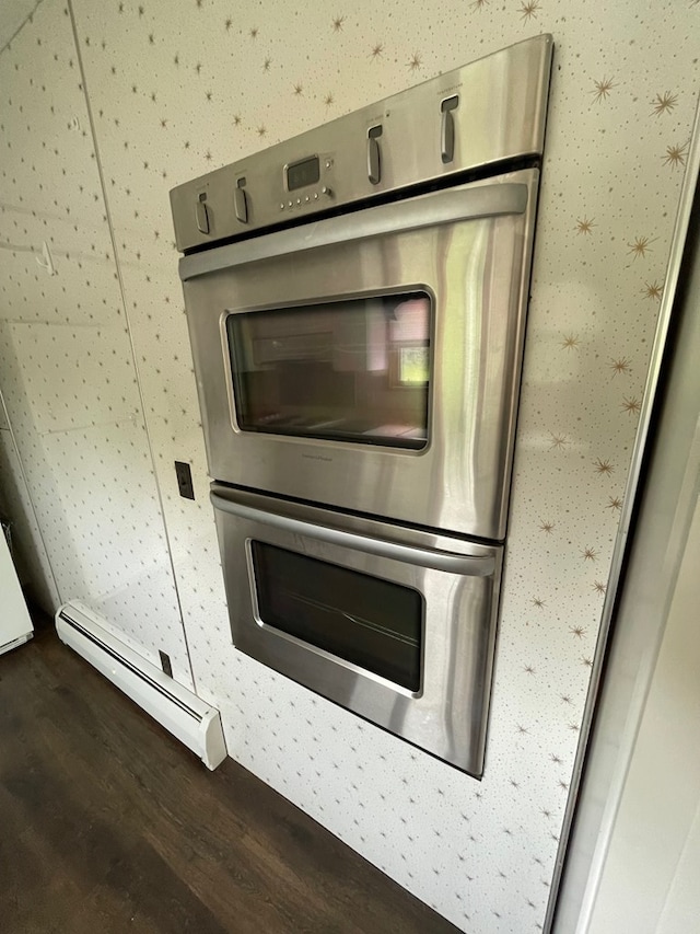401 Center St, Ulysses, PA 16948 - kitchen view of wood finished floors, baseboard heating, double oven, and wallpapered walls