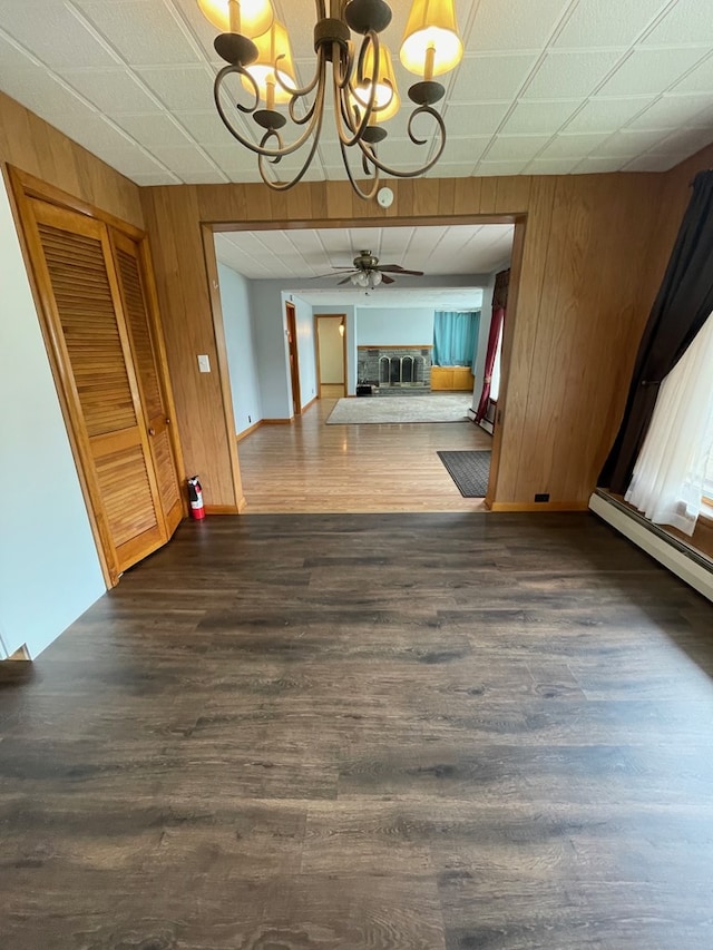 401 Center St, Ulysses, PA 16948 - corridor with a chandelier, wood walls, dark wood-type flooring, and baseboard heating