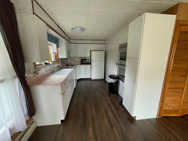 401 Center St, Ulysses, PA 16948 - kitchen featuring freestanding refrigerator, black microwave, dark wood-style floors, white cabinetry, and light countertops