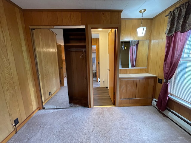 401 Center St, Ulysses, PA 16948 - unfurnished bedroom with wood walls, carpet flooring, a closet, and baseboard heating