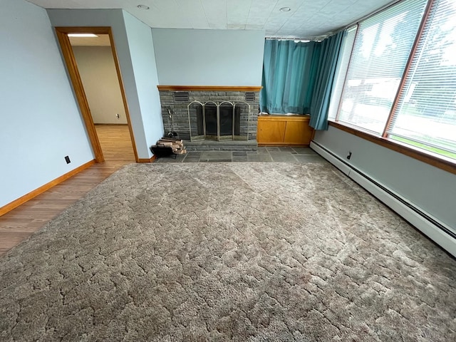 401 Center St, Ulysses, PA 16948 - unfurnished living room featuring a baseboard radiator, a fireplace, and wood finished floors