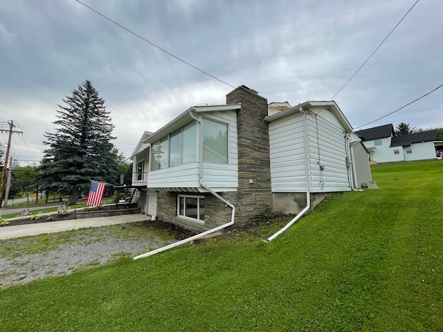 401 Center St, Ulysses, PA 16948 - view of home's exterior featuring driveway, a lawn, a chimney, and an attached garage