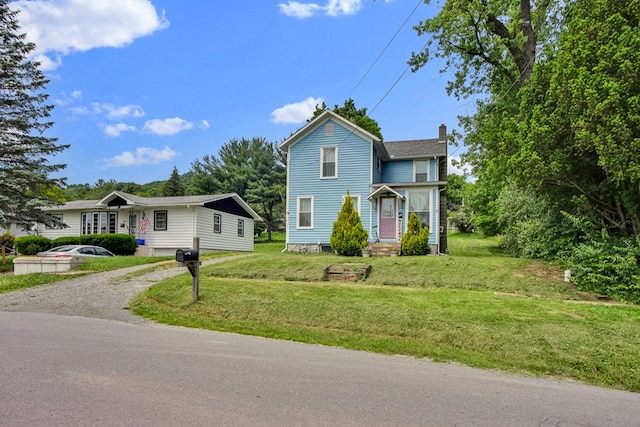 40 Wetmore St, Wellsboro, PA 16901 - traditional-style house with a chimney, gravel driveway, and a front yard