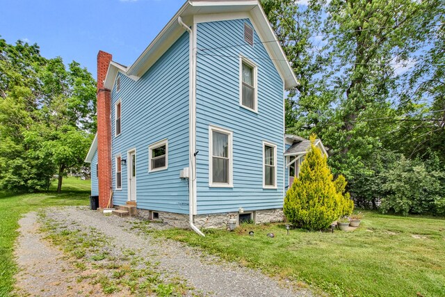 40 Wetmore St, Wellsboro, PA 16901 - view of side of property featuring a chimney and a lawn