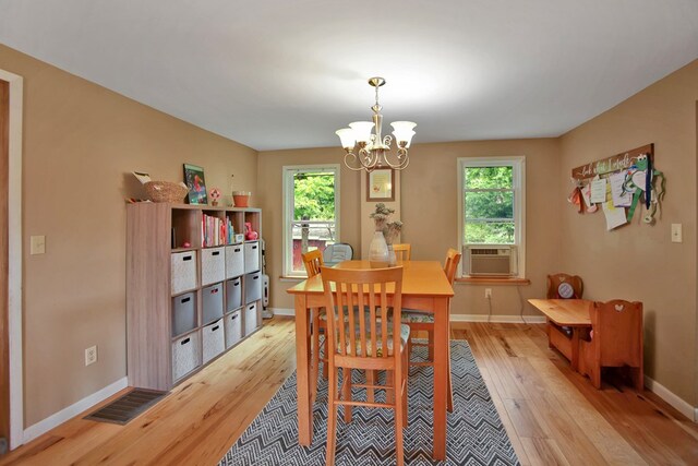 40 Wetmore St, Wellsboro, PA 16901 - dining area featuring cooling unit, light wood-type flooring, a chandelier, and healthy amount of natural light