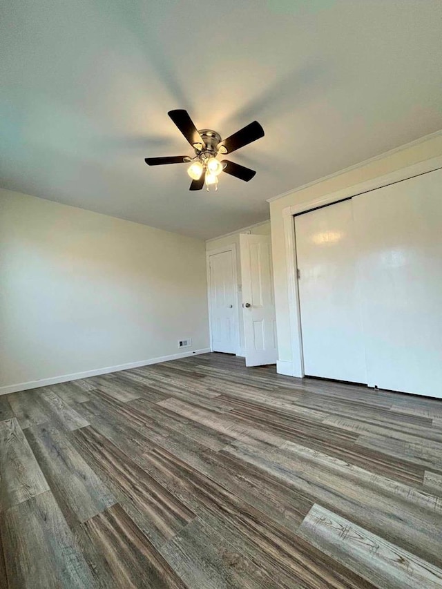 unfurnished bedroom with dark hardwood / wood-style flooring and ceiling fan