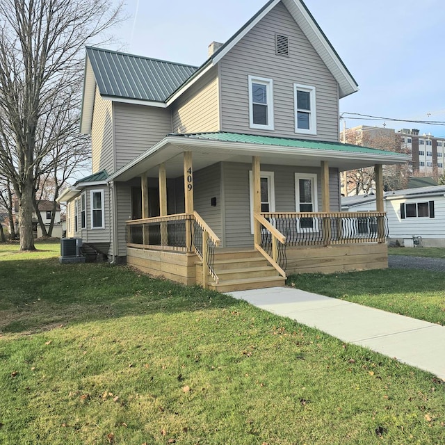 farmhouse featuring covered porch, a front lawn, and cooling unit