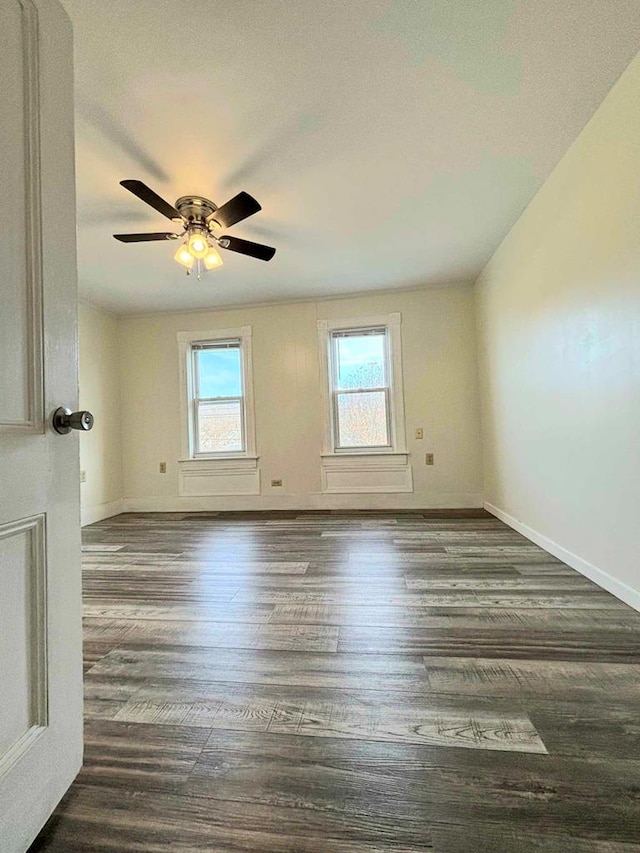 unfurnished room featuring a textured ceiling, ceiling fan, and dark wood-type flooring