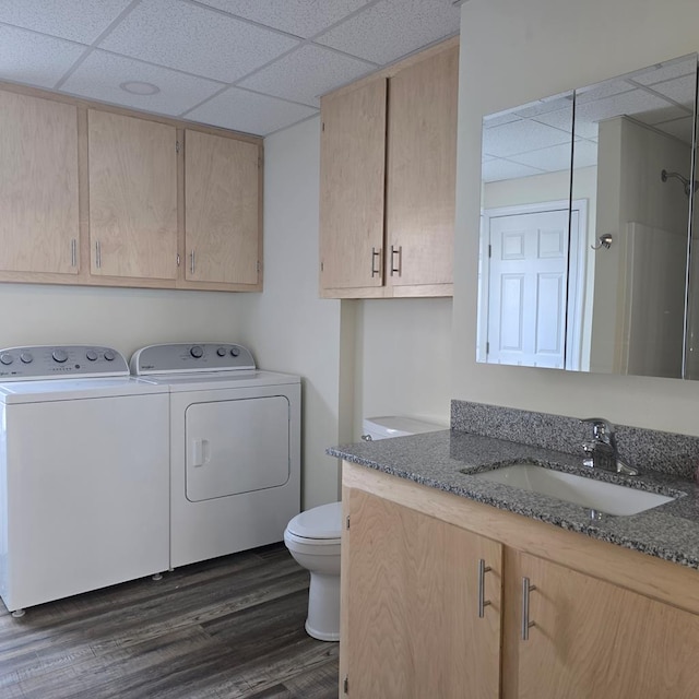 laundry room with separate washer and dryer, sink, and dark wood-type flooring