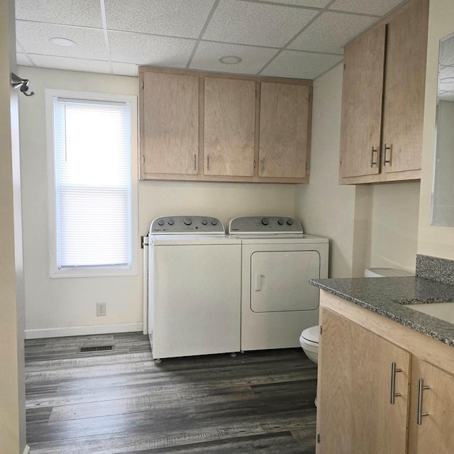 laundry area with washer and clothes dryer and dark wood-type flooring