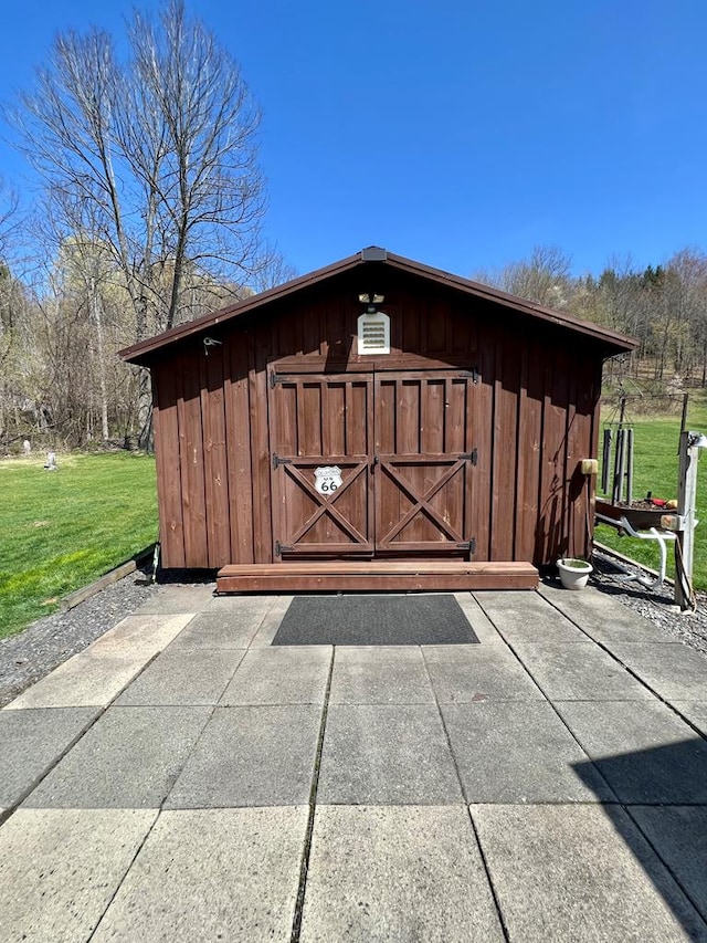 view of outbuilding featuring a lawn