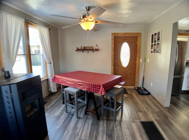 dining area with dark hardwood / wood-style floors, ceiling fan, and crown molding