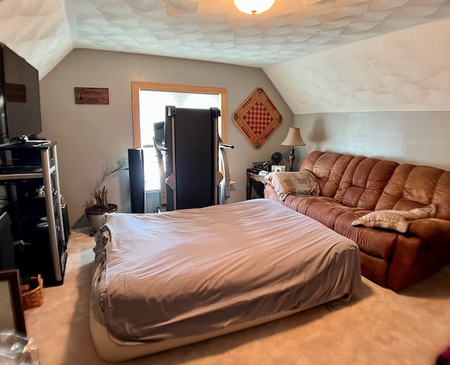 bedroom featuring light carpet, a textured ceiling, and vaulted ceiling