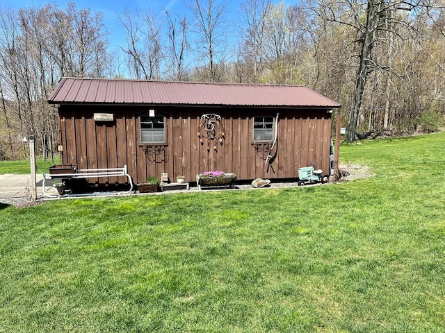 view of outdoor structure featuring a lawn