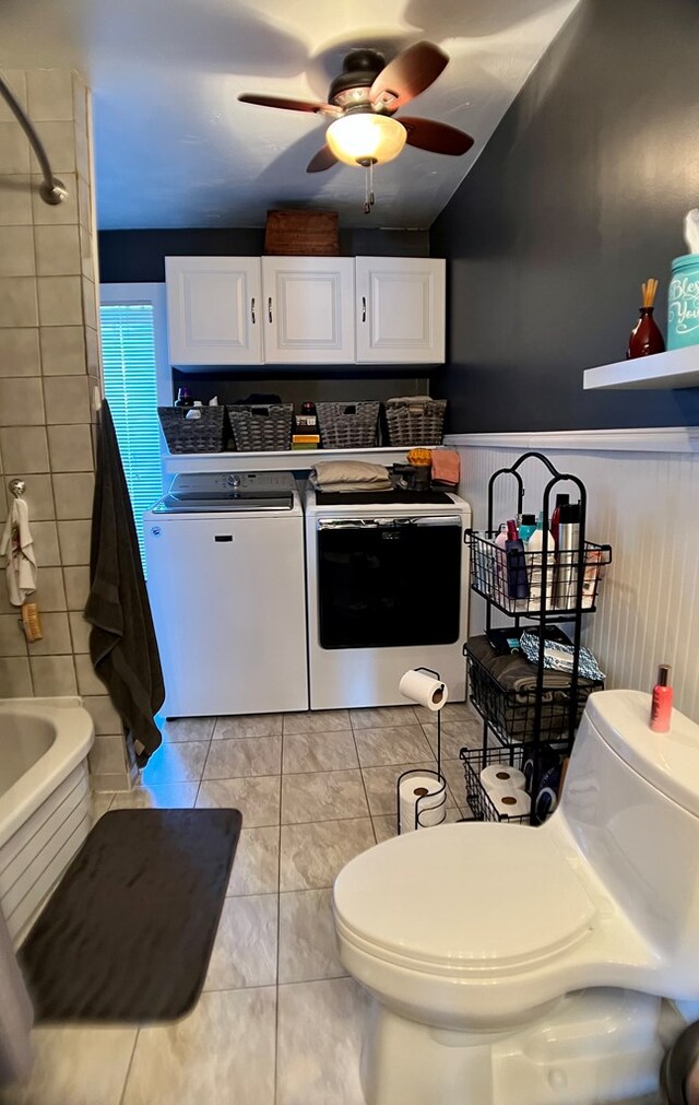 kitchen featuring washer and dryer, ceiling fan, light tile patterned flooring, and white cabinetry