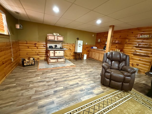 living area featuring wainscoting, log walls, wood finished floors, and wood walls