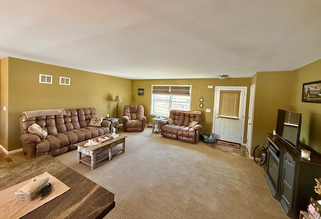 living area with visible vents and carpet
