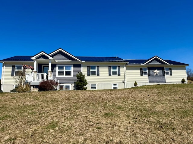 ranch-style home with a front lawn and metal roof