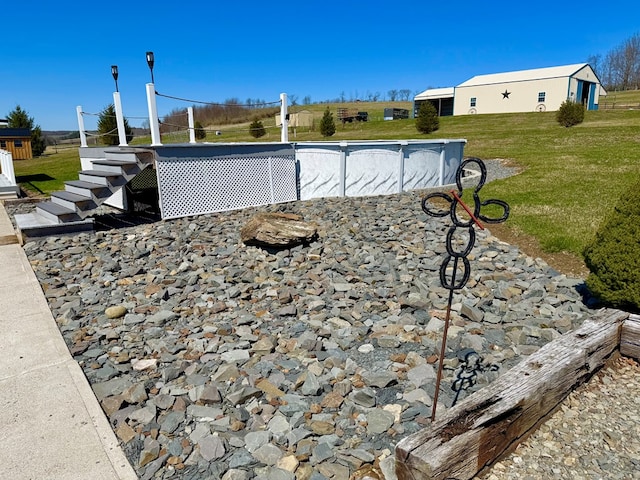 view of swimming pool featuring a lawn