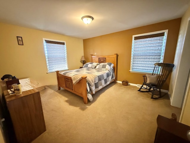 bedroom featuring baseboards and carpet